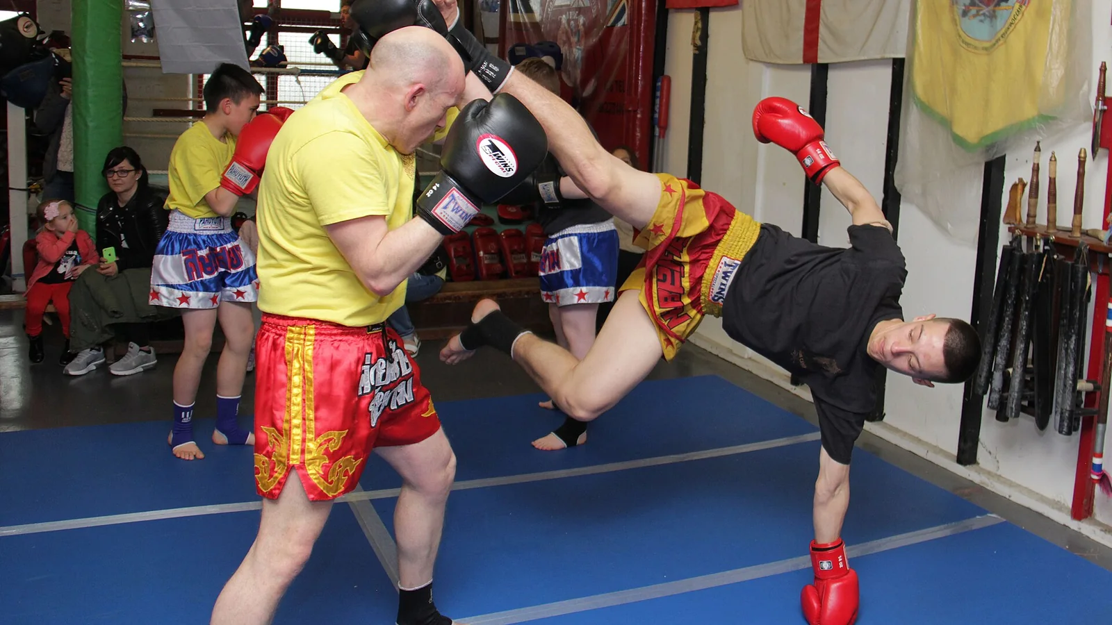 Muay Thai fighter delivering a high kick during training